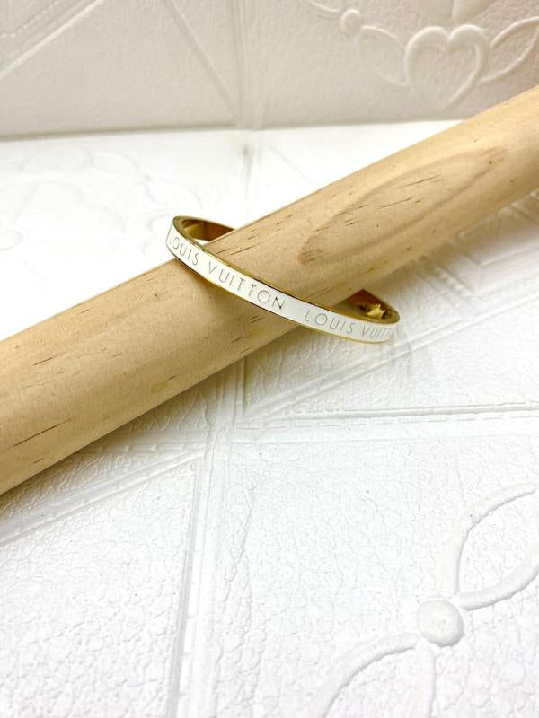 Pulsera De Acero Rigida Dorada Louis Vuitton Blanco