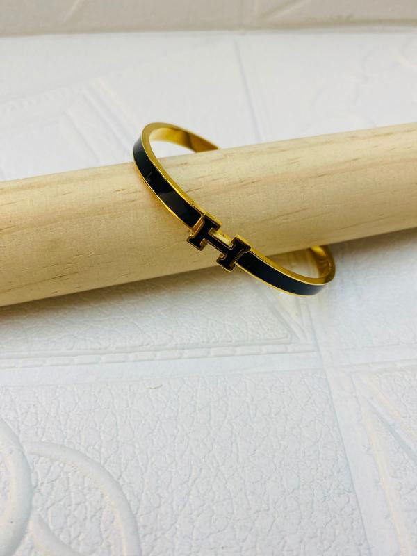 Pulsera De Acero Rigida Hermes Diseño H Negro Dorado
