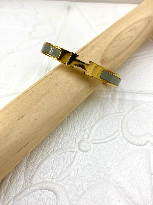 Pulsera De Acero Rigida Hermes Dorada Diseño H Gris